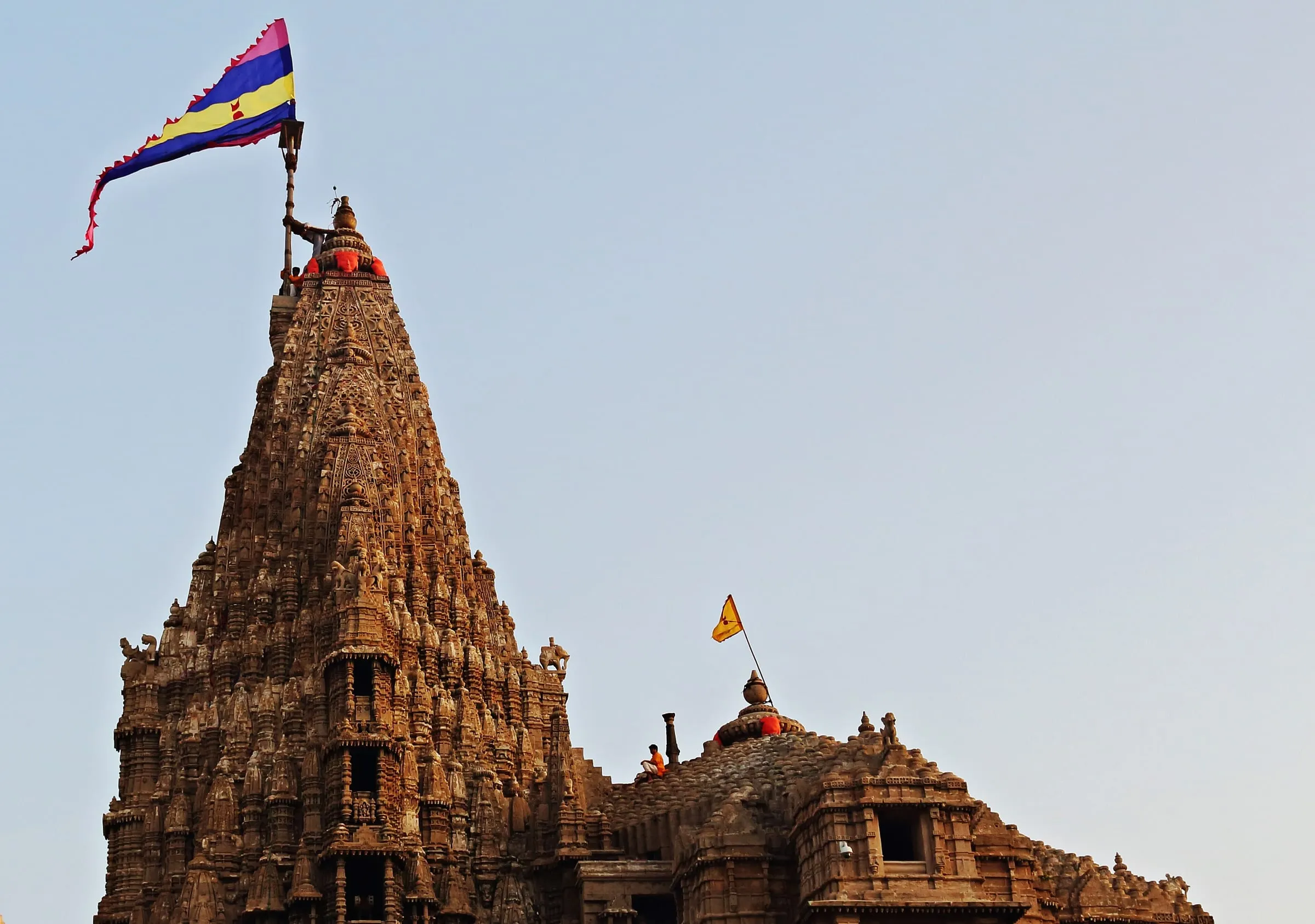 The flag being raised on the spire of Dwarkadhish Temple