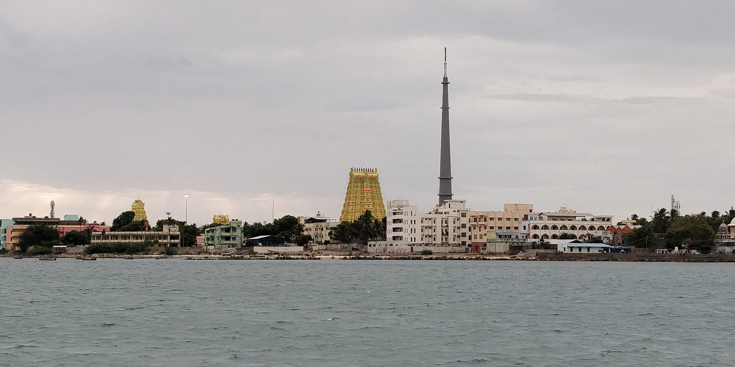 Rameswaram seen from the sea, with the temple's gopuram rising above the town