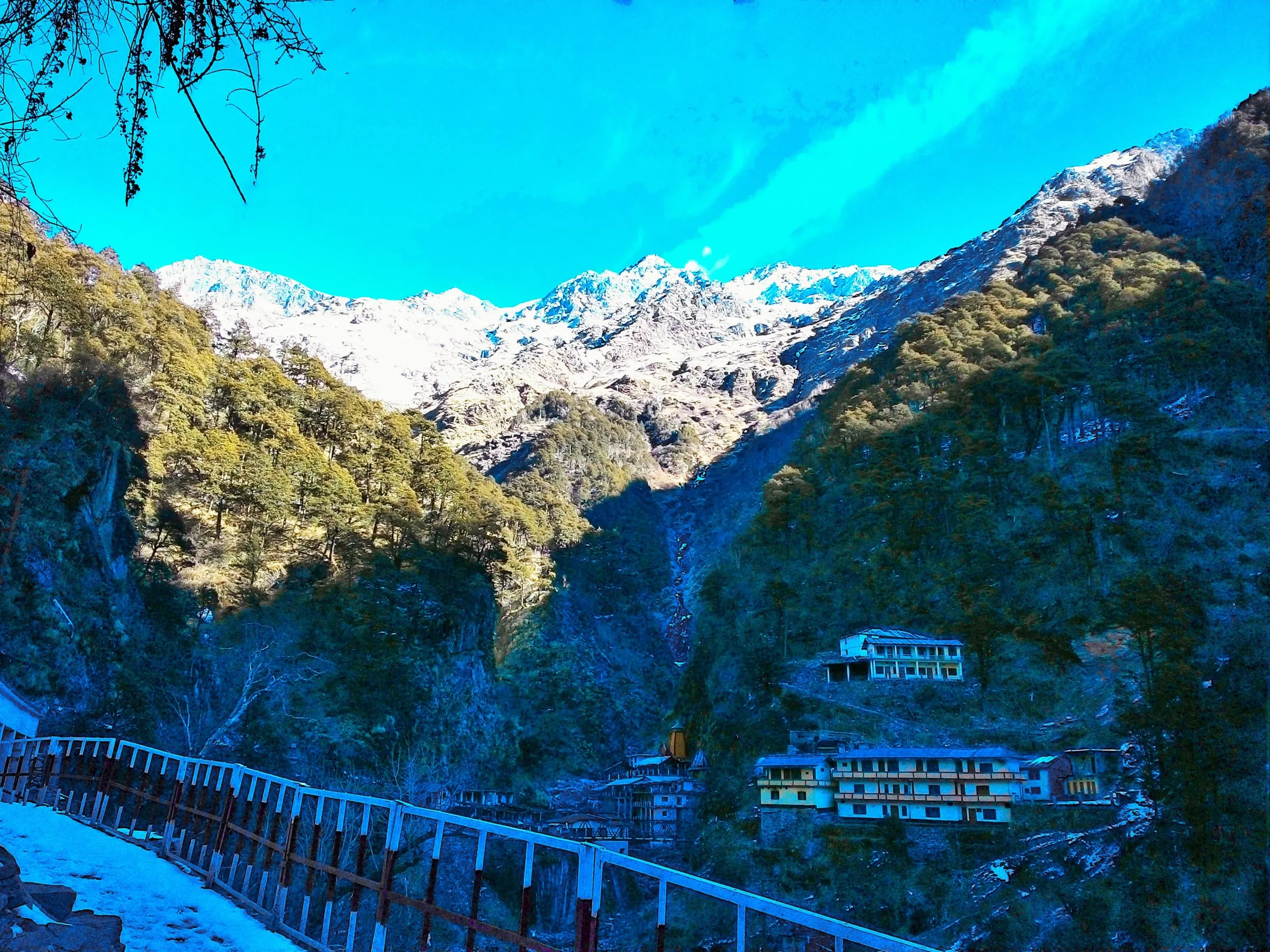 Yamunotri below the glacier, with snowy slopes above the valley