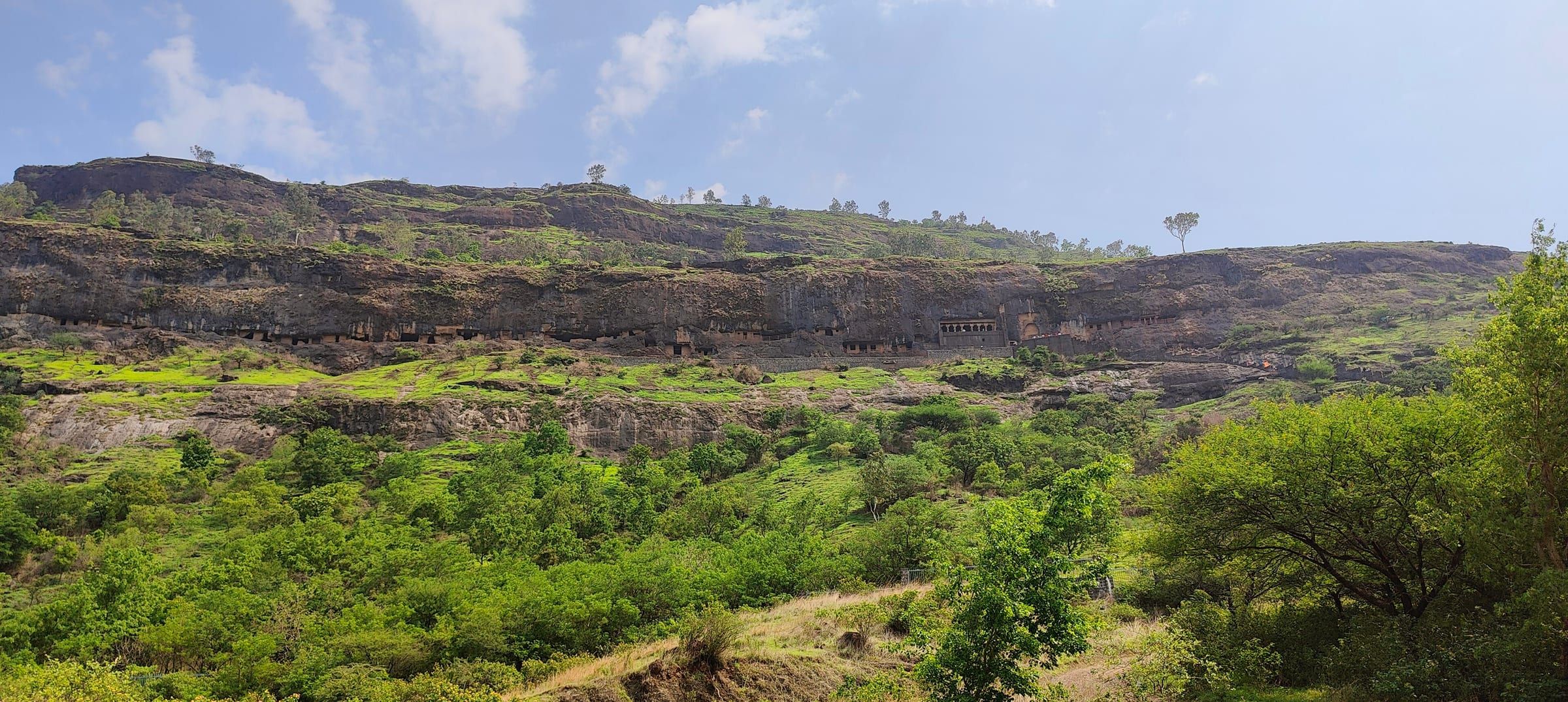 The Lenyadri hill near Junnar, with rock-cut caves in the cliff above green slopes