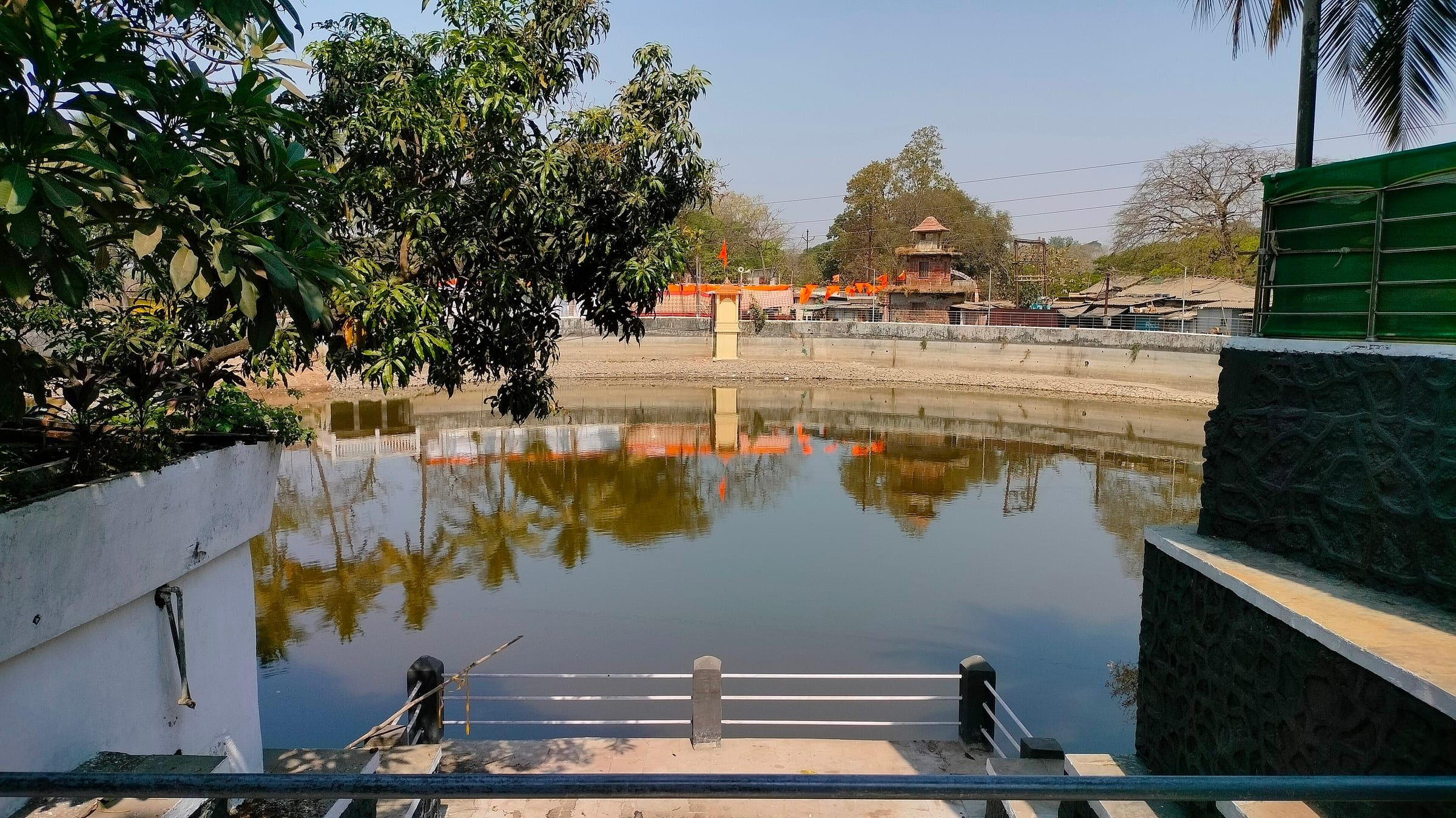 The temple pond at Varadvinayak, Mahad, fringed with trees