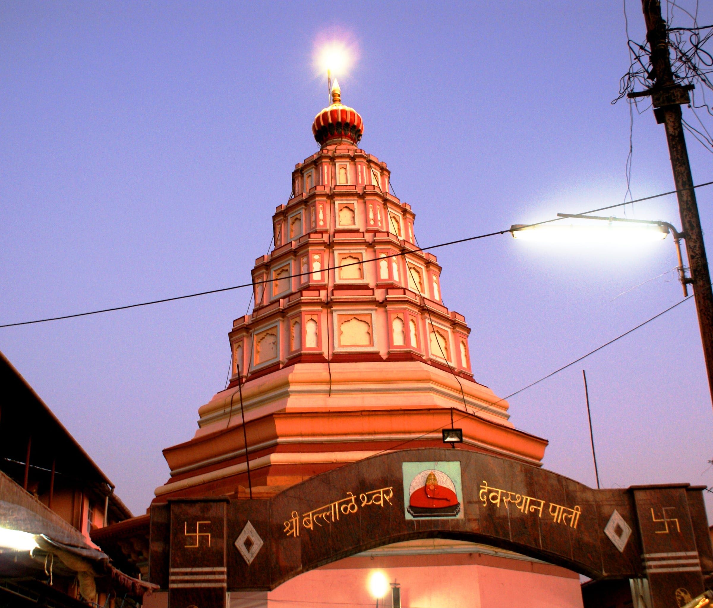 The orange spire of the Ballaleshwar temple at Pali at dusk
