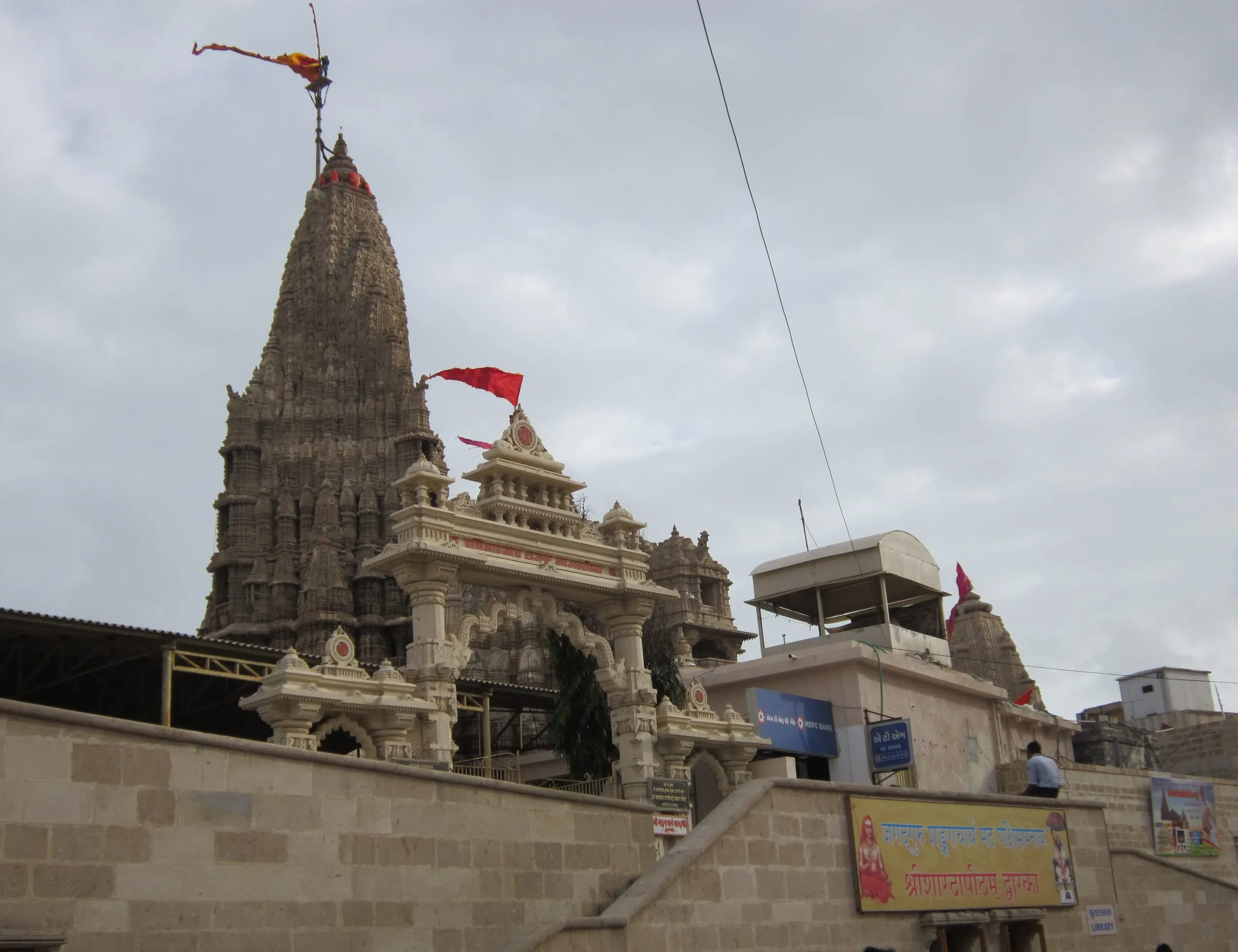 The carved spire of Dwarkadhish Temple, topped with its flag