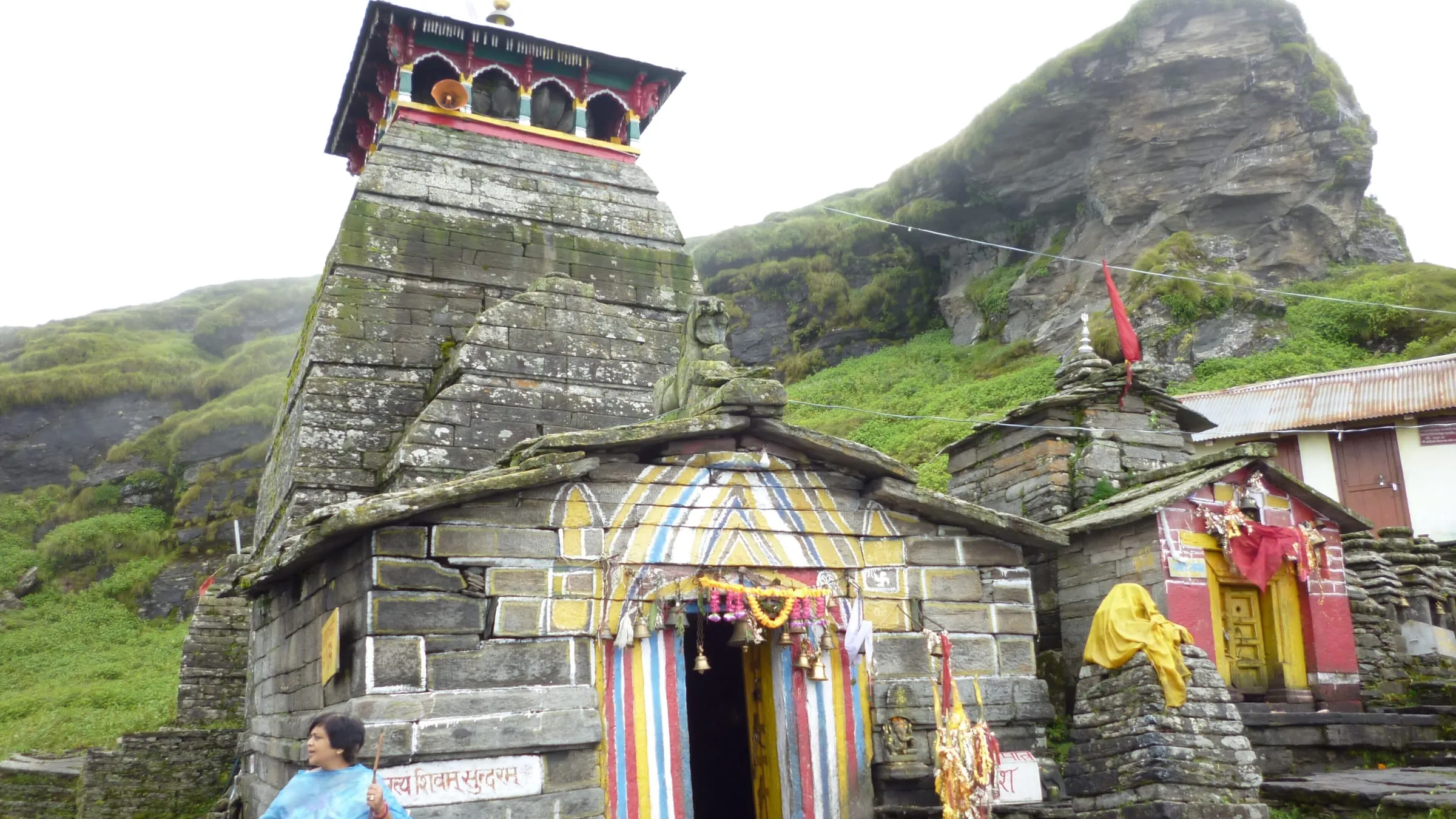 Tungnath Temple's stone spire with Himalayan slopes behind