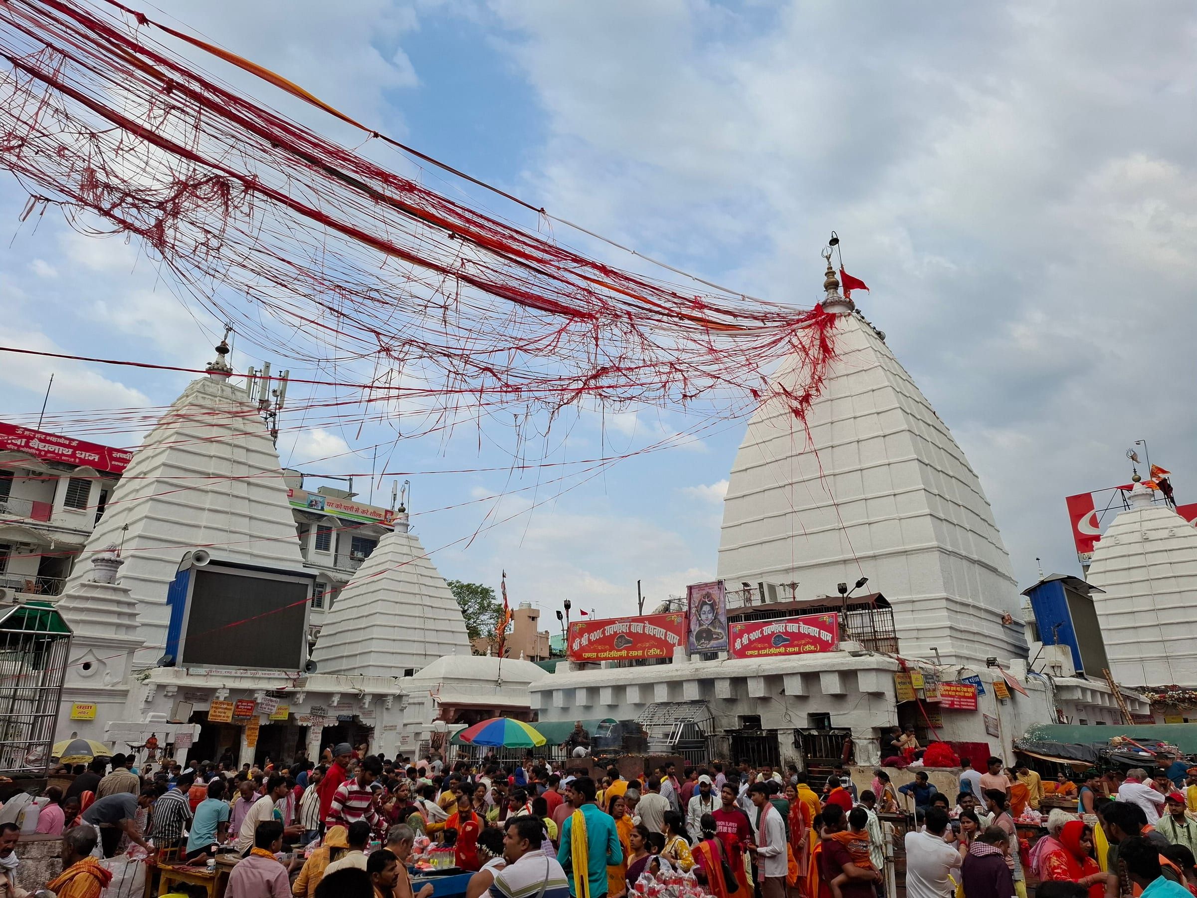 The white spire of the Baidyanath temple rising above the crowded temple courtyard in Deoghar