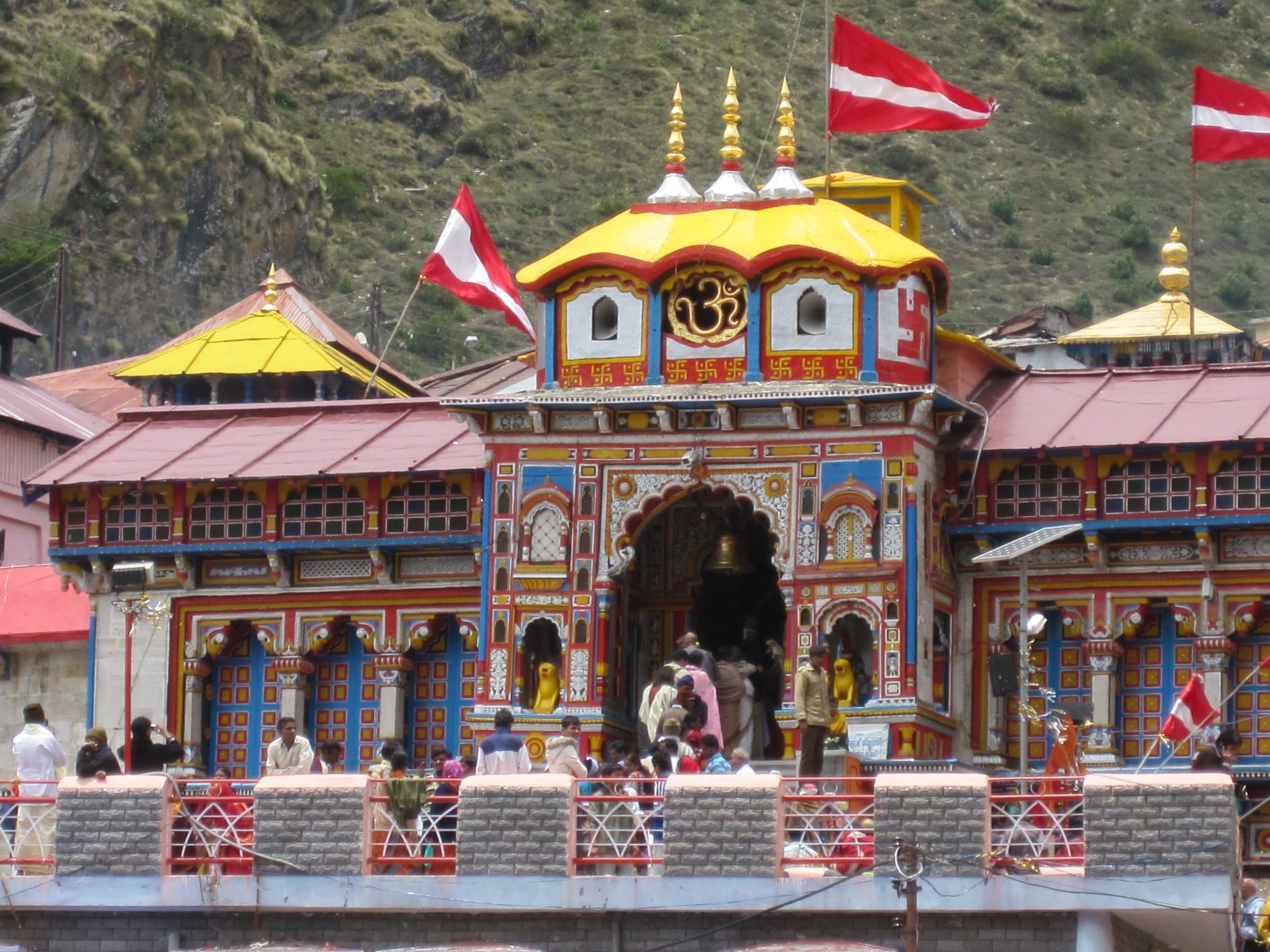 Badrinath Temple's brightly painted gateway and spire, with mountains behind