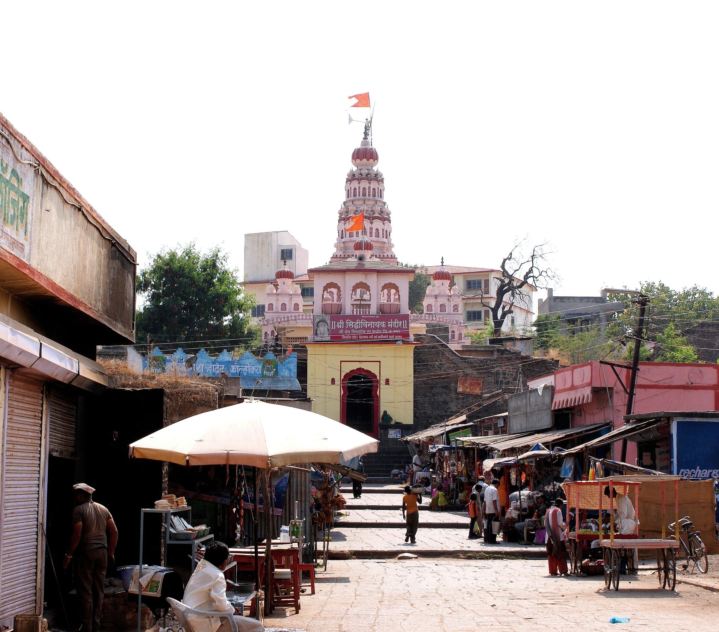 The spire of the Siddhivinayak temple at Siddhatek above a crowd of pilgrims