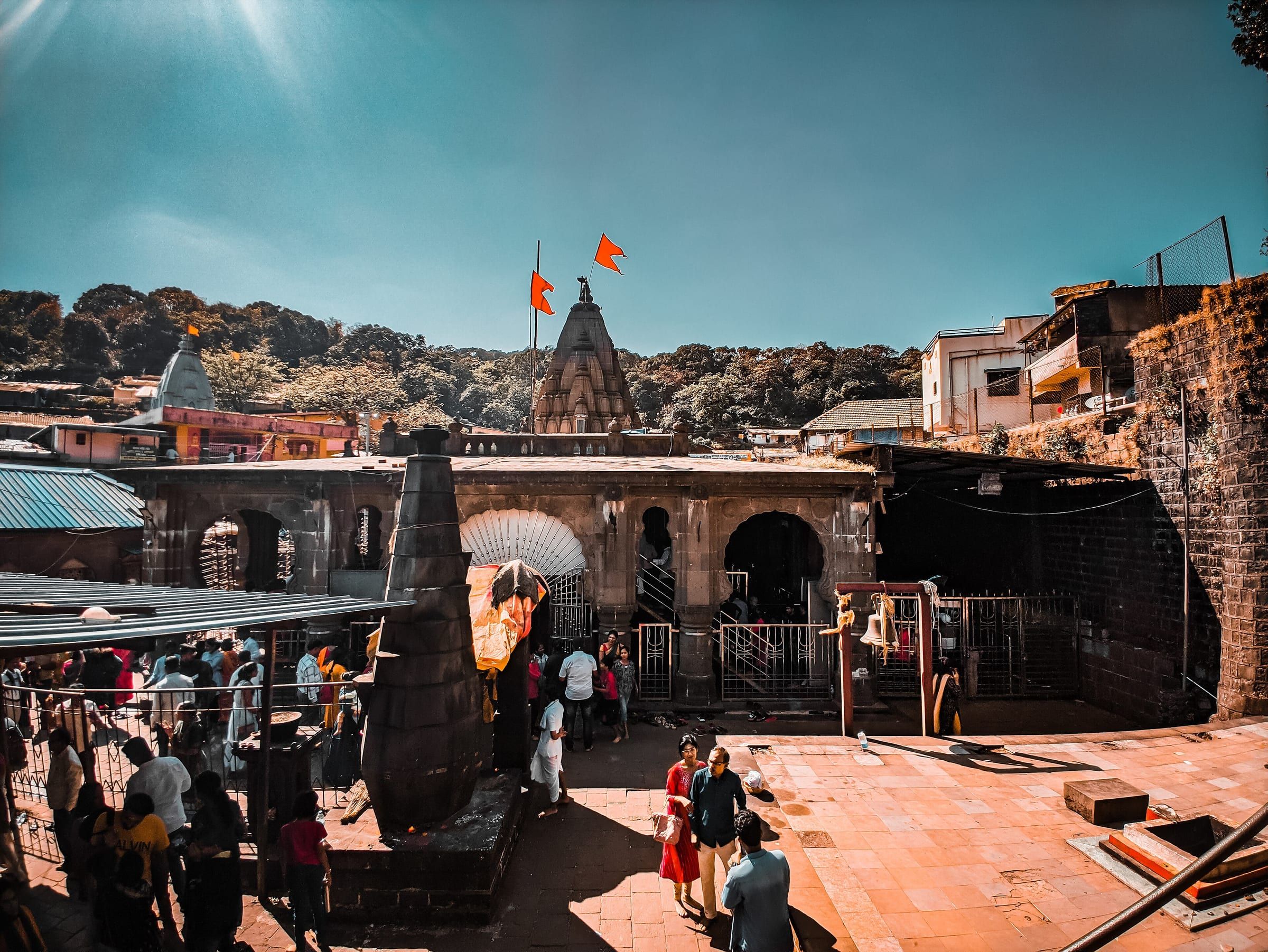 Bhimashankar Temple's black stone spire and entrance under a blue sky
